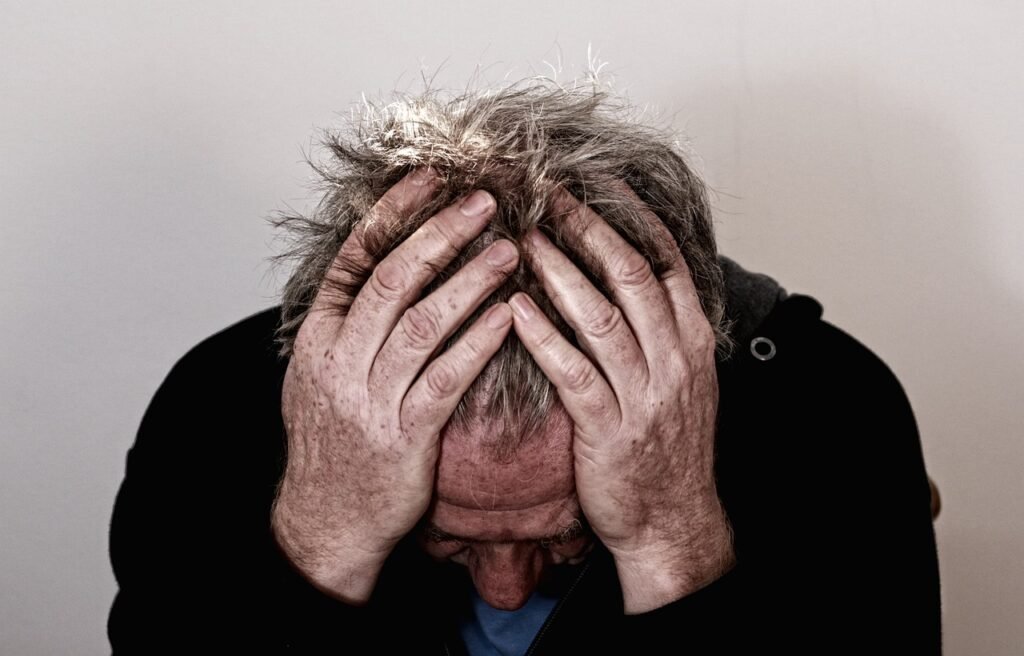 Individual holding head in pain due to sinus infection complications